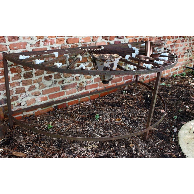 A mid-19th century large French iron fan light, now mounted as a garden serving table. 70 1/2" w., 35 1/4" d., 28"h.