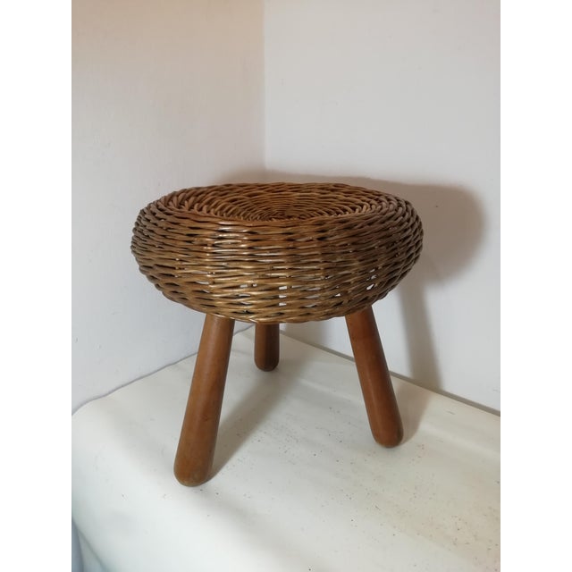 Wicker stool designed by Tony Paul. Made in the 1950s, it features hand-woven wicker for the seat and solid wood for the...