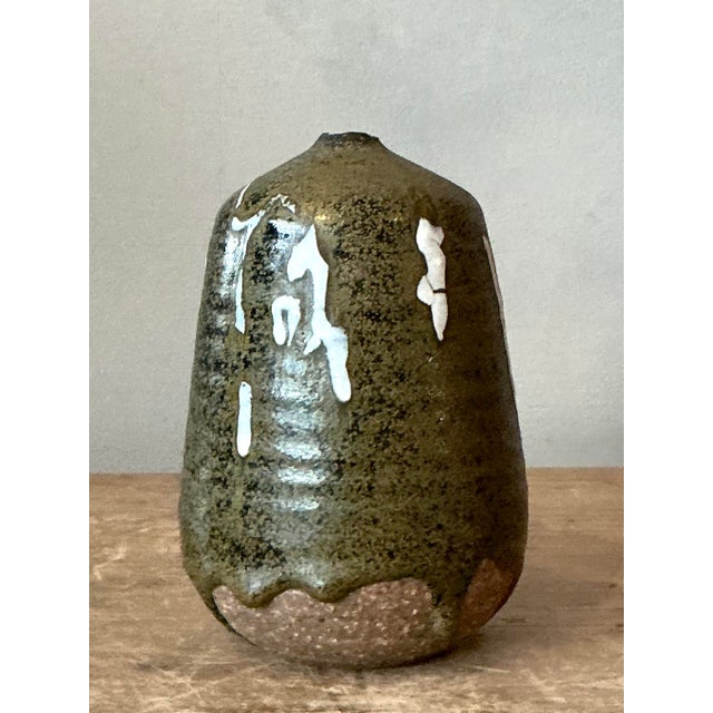 Celebrate the imperfect beauty of the American studio pottery movement with this charming vintage "weed pot" vase. Hand-...
