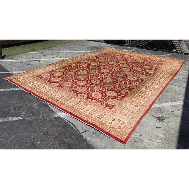 Design Plus Gallery presents a 13ft x 17ft 10in Afghan Area Rug. The rug has been hand knotted with a maroon border and...