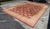Design Plus Gallery presents a 13ft x 17ft 10in Afghan Area Rug. The rug has been hand knotted with a maroon border and...