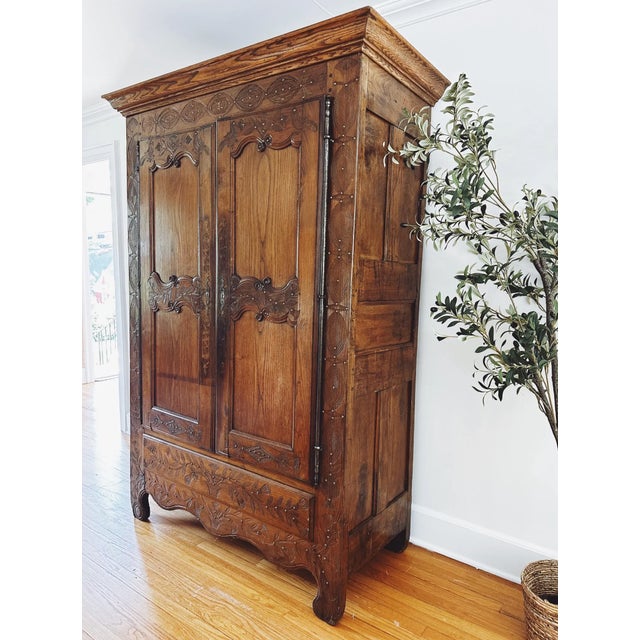 This 1867 French oak armoire is a stunning example of 19th-century craftsmanship, hand-carved with remarkable detail that...