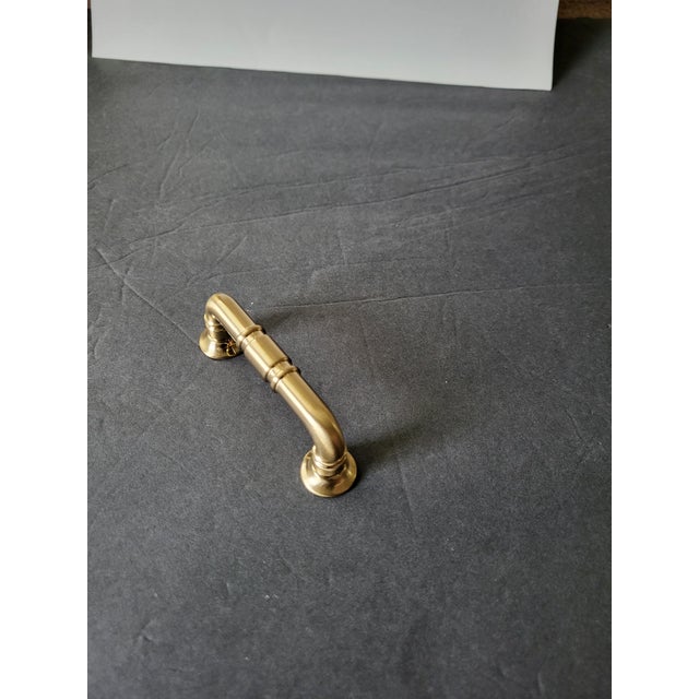 Very heavy but graceful solid brass door handle from the 1990s. New but opened package, and made by Kent