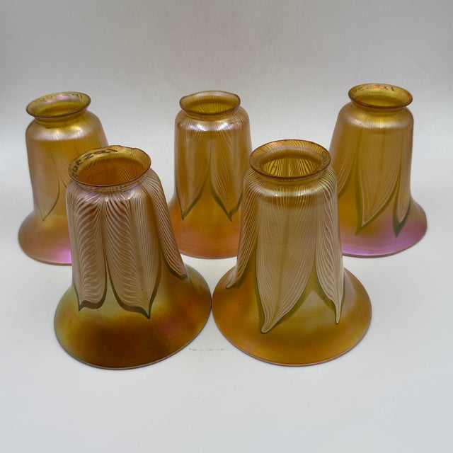 American, early 20th century, Quezal Art Glass and Decorating Company, Brooklyn, NY. A matched-in-style set of five...