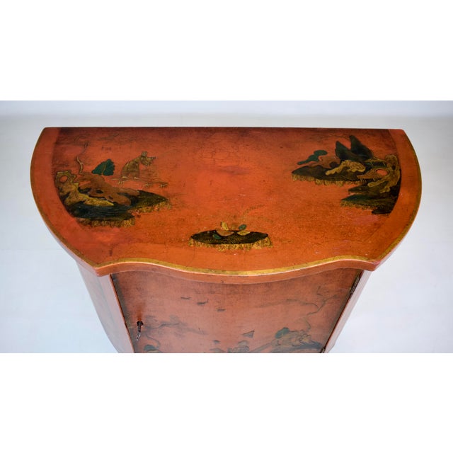 An early 20th century red Lacquered Chinoiserie Demi-lune side table, console cabinet having a single locking door & loose...