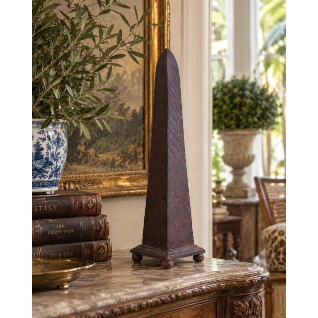 A beautifully proportioned rust color metal obelisk. The sculptural silhouette and pattern detail give the piece a quietly...