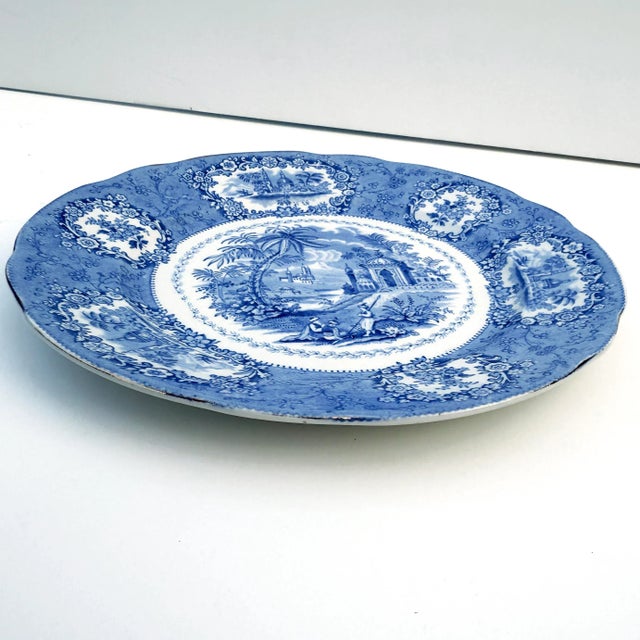 Classic Staffordshire transferware plate by Ridgways in the “Oriental” motif. Features delicate blue and white decoration...