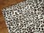 Exquisite one-of-a-kind handwoven Turkish superfine wool on silk rug with all-over leopard motif in clear white and dark...