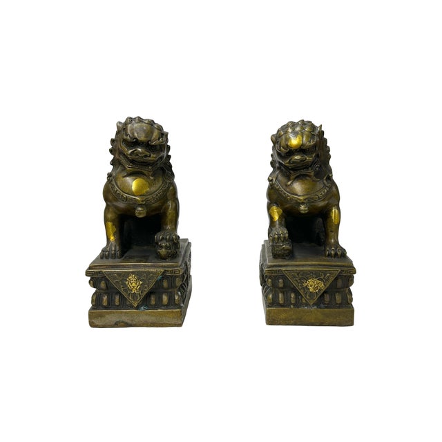 This pair of ornate Chinese Guardian Lion statues, commonly known as Foo Dogs, is cast in a heavy, dark-patinated bronze...