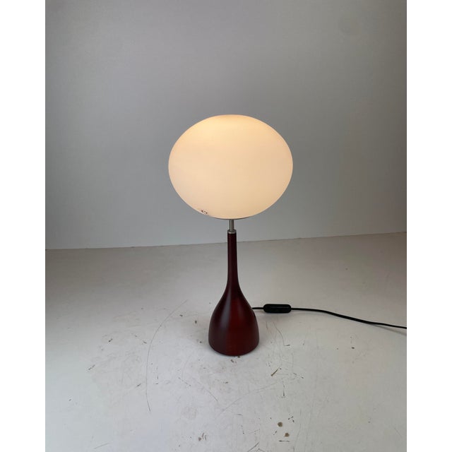 Beautiful and elegant table lamp made of a mahogany tulip foot and a satin blown murano glass diffuser. Named sphera t,...
