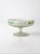 This vintage satin glass compote features a softly frosted finish, a low pedestal base, and hand-painted floral accents...
