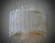 This shield-shaped wall light features a stunning design, entirely sandblasted with a unique finish on the visible surface...