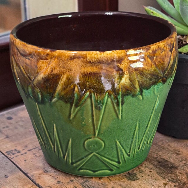 The Robinson Ransbottom Sun & Moon Glazed Pottery Jardinière Planter is a vintage piece made of green and brown glazed...