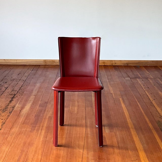 Set of four dark red leather chairs with a metal frame. Made in Italy by Frag. An elegant and timeless design. Similar in...