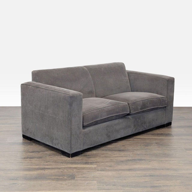 This Room & Board loveseat features a clean, modern design with wide arms and comfortable, deep cushions. The soft gray...