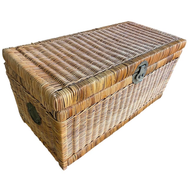 This is a vintage woven wicker storage trunk with a warm, natural honey-brown tone and classic craftsmanship. Description:...