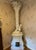 Antique Continental glazed terracotta stove in chinoiserie motifs. In off white glaze with frothy palm leaf finial at the...