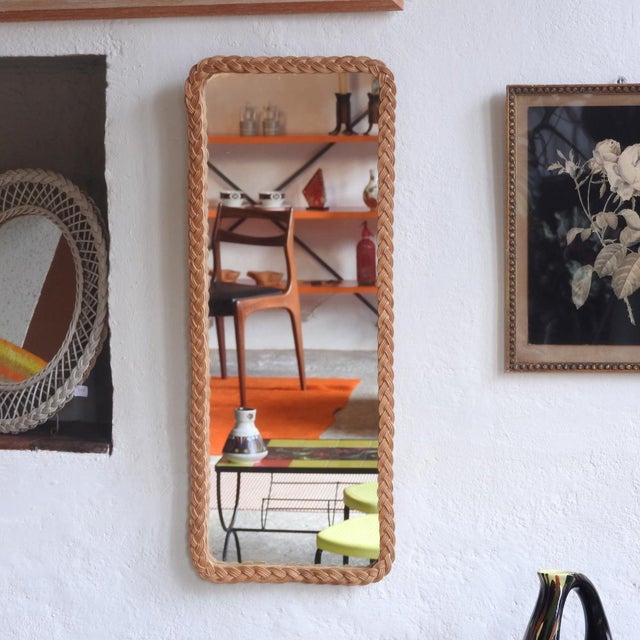 Vintage organic wall mirror with a woven wicker frame. It is rectangular with rounded corners. France, 1960s Completely...