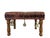 This is a small, rectangular wooden stool with four turned legs. The seat is cushioned and upholstered in worn brown...