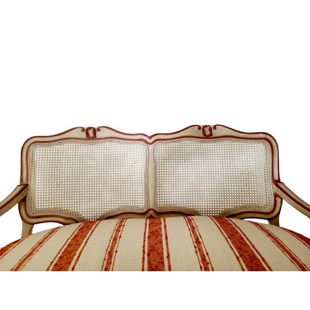 Lovely W&J Sloane French Provincial/ Louis XV style, double-arched cane back settee. It has cabriole legs with gently...