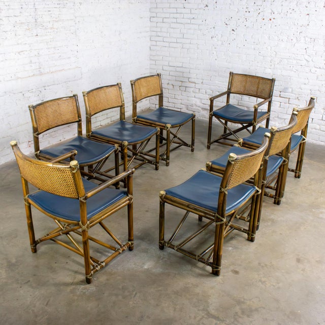 Magnificent vintage Campaign style set of 8 dining chairs by McGuire composed of rattan frames, cane seat & double wall...