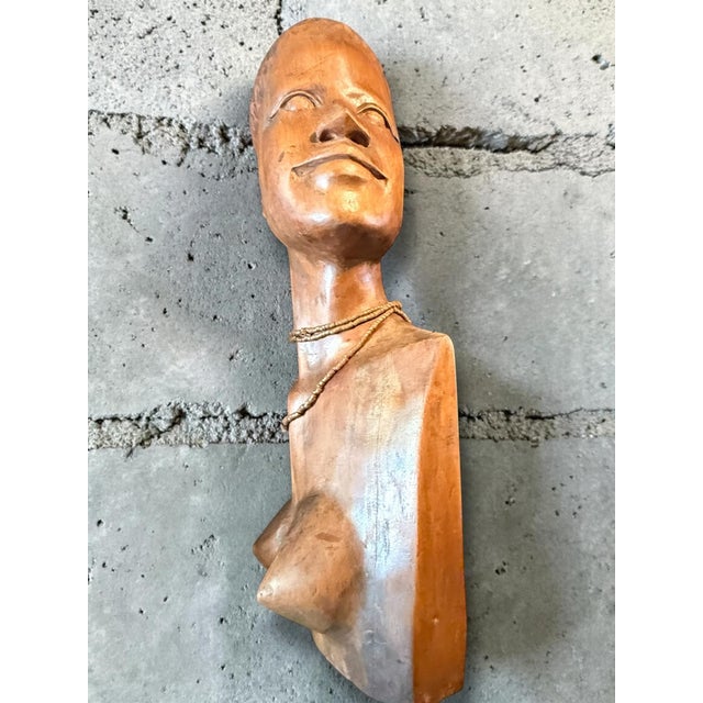Beautiful large hand-carved wooden bust of a female figure in African style, dating from circa 1960. This sculpture...