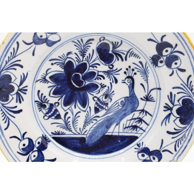 Late 18th century Delft peacock motif blue & white plate, Dutch. A grand garden with peacock & flowers, the border also...