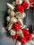 Bright and shiny holiday wreath made up of small red and silver vintage-style bulb ornaments on heavy wire frame with rope...