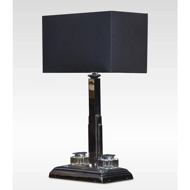 Art Deco chrome desk lamp with the square stepped stem supported on a rectangular base with inset inkwells and pen rest....
