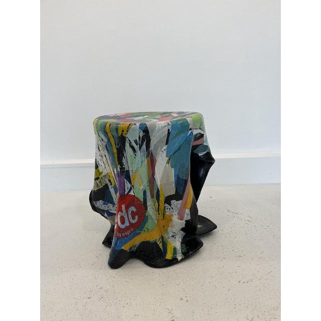 An original object made from recycled plastic, hand-painted and coated in multicolored layers of resin.