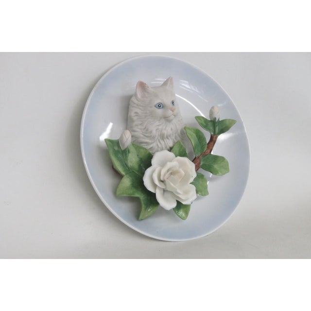 This beautiful Cat with Roses Plate is made of porcelain ceramic. This stunning decorative plate presents a 3D raised...