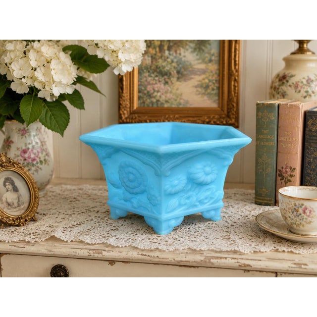 Beautiful vintage Fenton satin blue glass footed jardiniere/cachepot featuring an elegant embossed floral motif and softly...