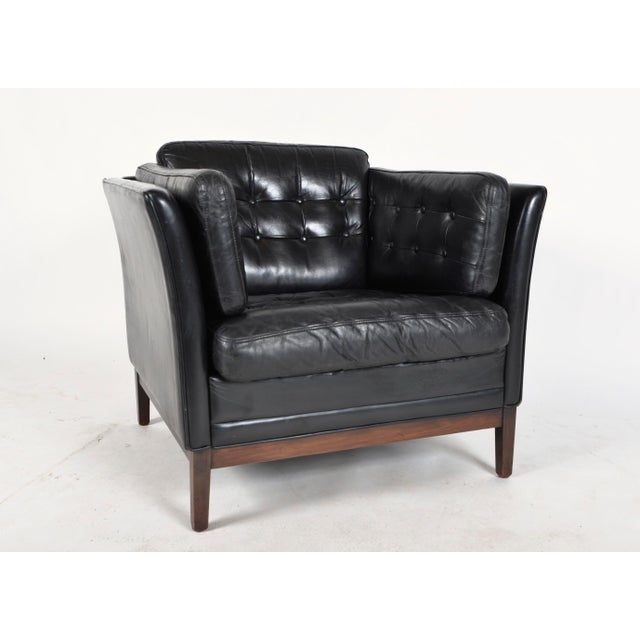 A generous 1960s danish club chair by mogens hansen, retaining its original top grade black leather and built for comfort,...