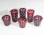A set of six red cut to clear glasses. Included are three tall glasses and three tumblers. Each glass has a red cut to...