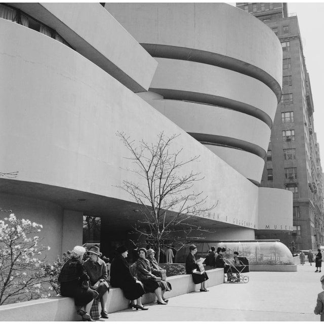 Outside The Guggenheim Women sitting on the wall outside the Solomon R. Guggenheim Museum in the Upper East Side of...