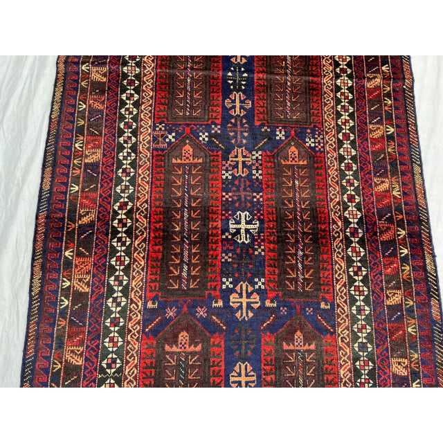 This exceptional vintage Afghan Baluchi rug features a striking geometric tribal design, showcasing traditional...