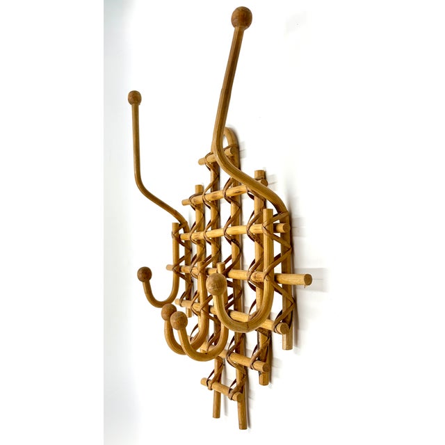 A stylish boho Mid-Century French rattan and burnt bamboo bentwood wall hook coat and hat rack with six hangers. It's a...