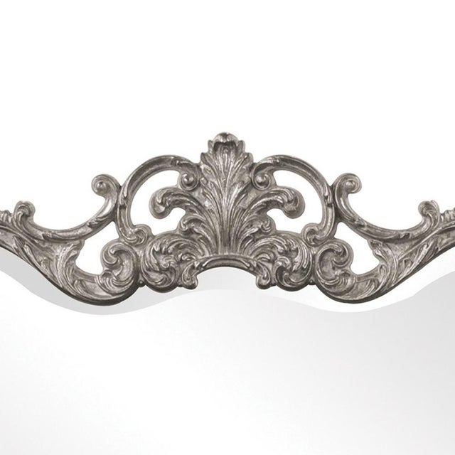 The Talida Mirror is a lovely piece featuring an ornate, textured frame adorned with decorative flourishes. The entire...