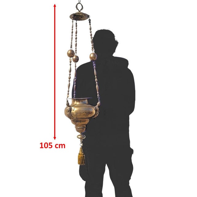 Large bronze sanctuary lamp consisting of three long, ornate chains with balls, and a bronze bowl decorated with three...