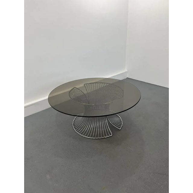 Beautiful vintage coffee table with chrome wireframe bas and smoke glass top. In good vintage condition. The glass has one...