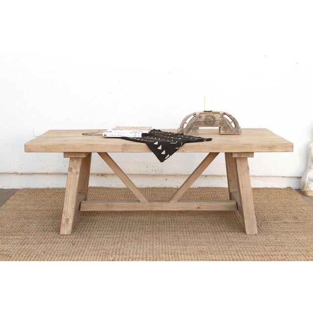The Roussillon runs on a tavern-style trestle base, the kind French farmhouse tables have used for generations: two angled...