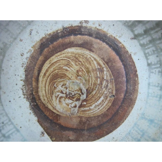 Fine Chinese earthenware shallow bowl, earth tones with pale blue to green lattice design around edge and circular brown...