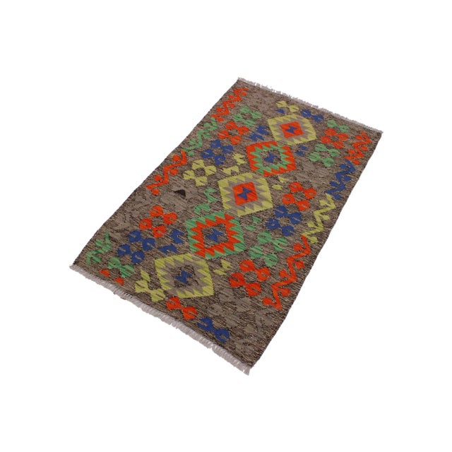 "Add a touch of elegance to your home with this casual chic hand woven Tribal Kilim wool rug. Constructed on a loom by...