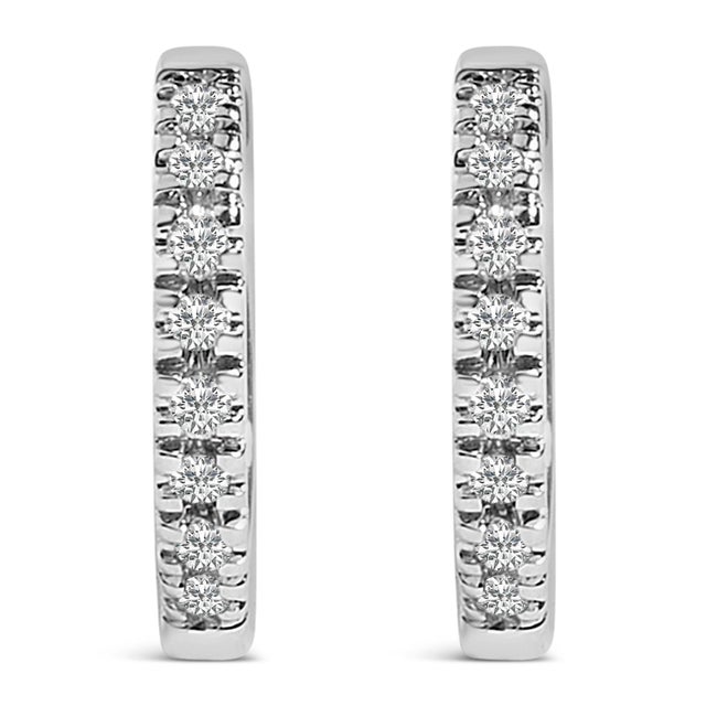 Immerse yourself in the understated elegance of these 14K White Gold huggie hoop earrings, each piece glistening with...