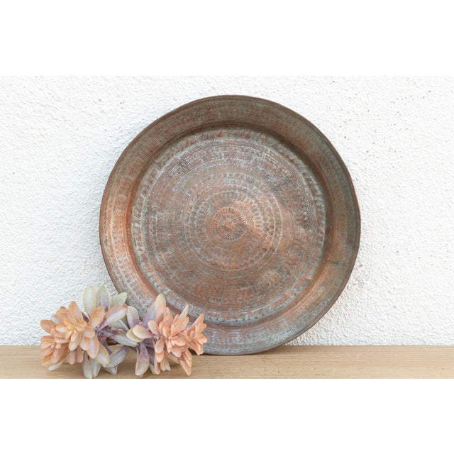 While many Indian trays feature soft floral patterns, this 15-inch charger is bold and geometric. The surface is covered...