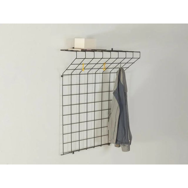 Classic wall wardrobe from the 1960s with colorful coat hooks. High-quality metal frame with black plastic coating. Made...