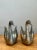 Sculpted with graceful arched necks and poised upward-swept wings, this vintage pair of cast metal swan figurines captures...