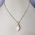 14 Karat Yellow Gold Opal and Diamond Pendant Necklace- This elegant pendant features one marquise shaped white cabochon...