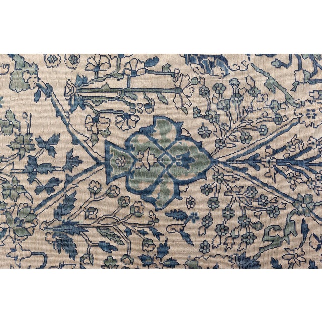 An early 20th century antique Indian garden rug. The main field features large scale blossom palmette-heads with angular...