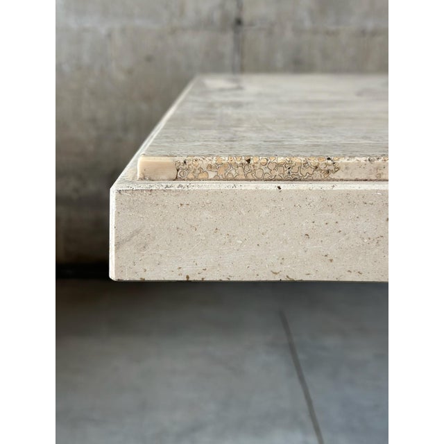 An Italian travertine center table by Maurice Villency. Post modern period, the square table top with a double beveled...